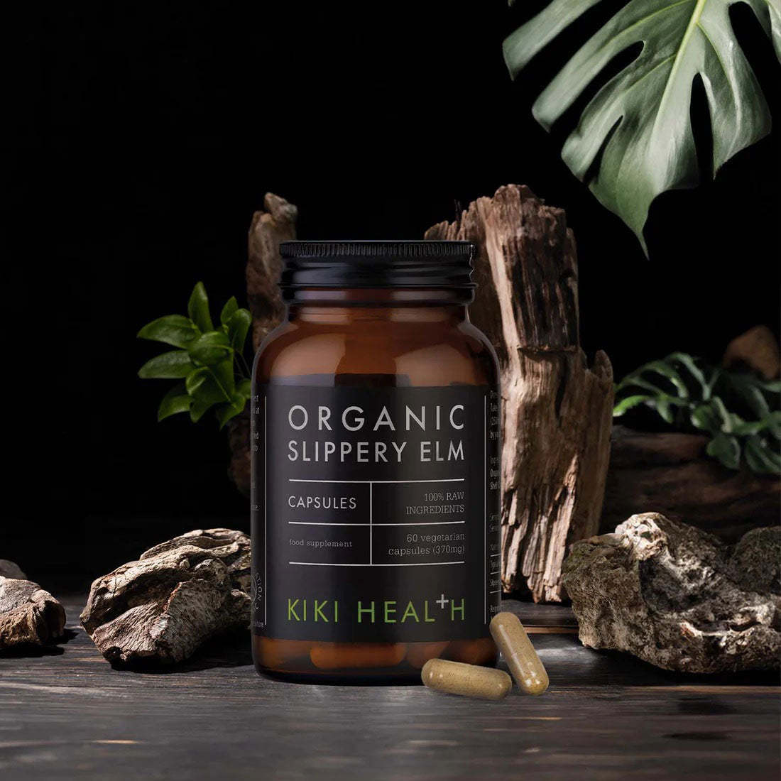 Herbalistas Kiki Health Organic Slippery Elm supplement capsules in a bottle, showing green capsules inside.