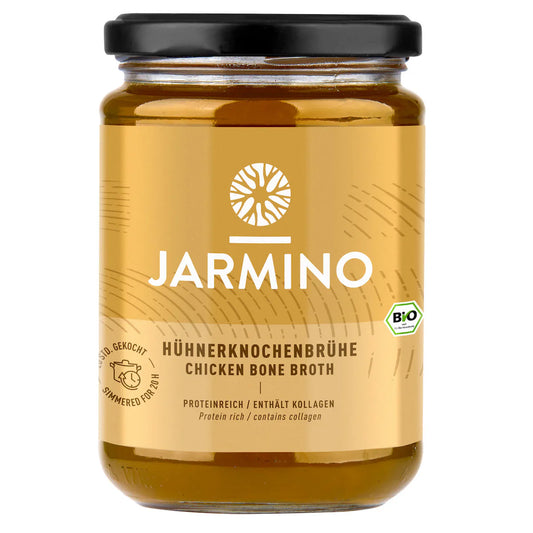 Jarmino organic chicken bone broth in a glass jar, rich in collagen, showcasing the nutrient-dense broth with visible chicken bones.
