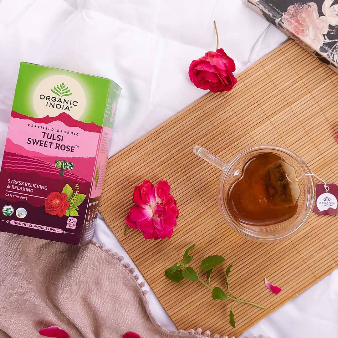 Organic India BIO Tulsi Sweet Rose Tea in 25 infusion bags, featuring blooming rose petals and fresh tea leaves.
