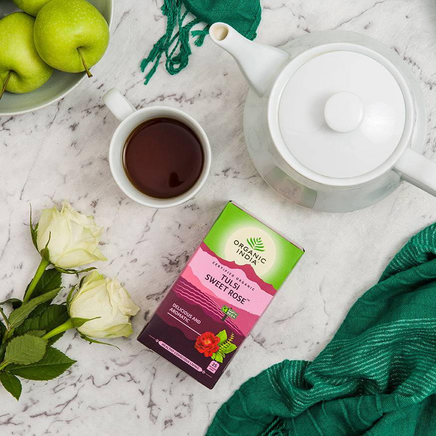 Organic India BIO Tulsi Sweet Rose Tea in a box of 25 caffeine-free infusion bags, featuring rose and Tulsi herbs.