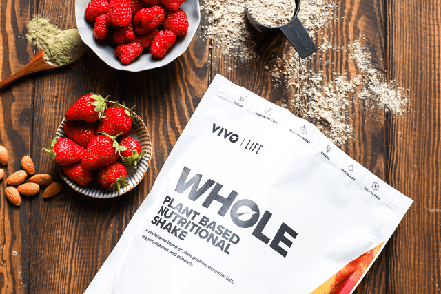 Vivo Life Whole Plant Based Nutritional Shake supplement in a flat-lay image, featuring the product packaging and ingredients.